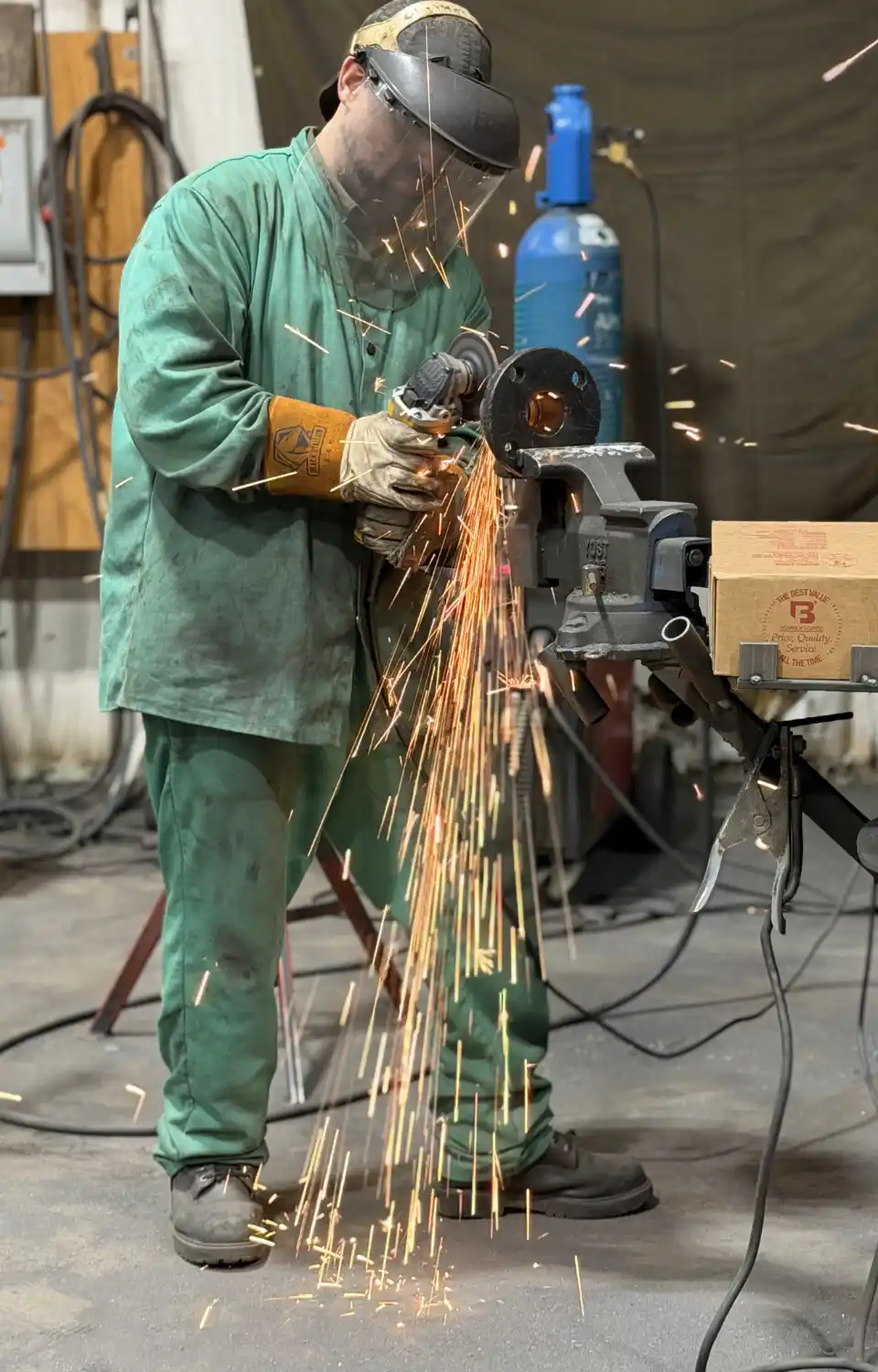 Filter Fab employee sanding metal